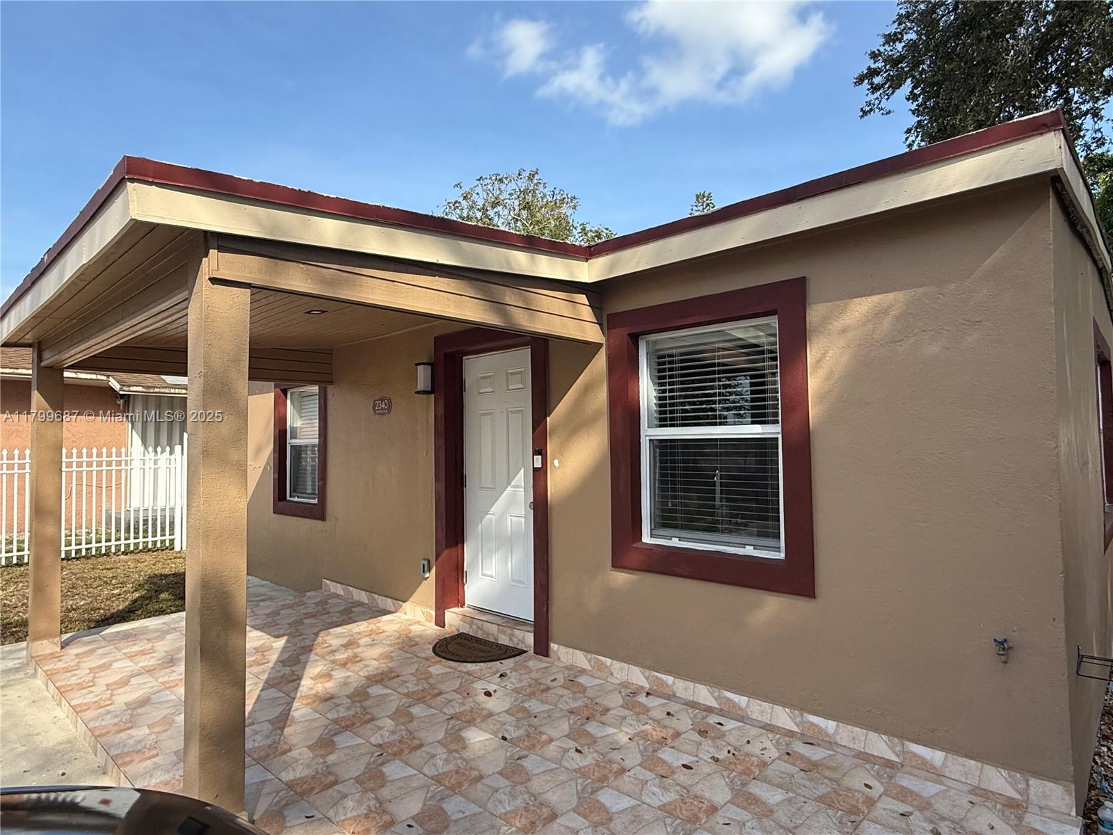 2340 Service Road Opa-Locka, FL 33054 - Photo 3 of 29 a view of a house with a small yard and wooden floor and fence
