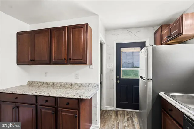 a kitchen with stainless steel appliances granite countertop a refrigerator and a sink