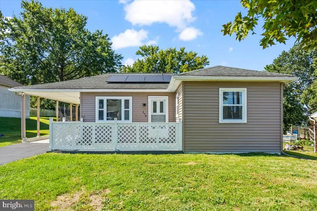 a front view of a house with a garden