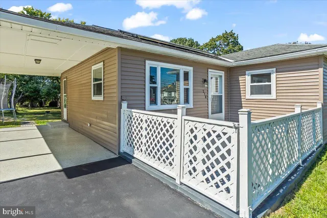 a view of a house with wooden fence