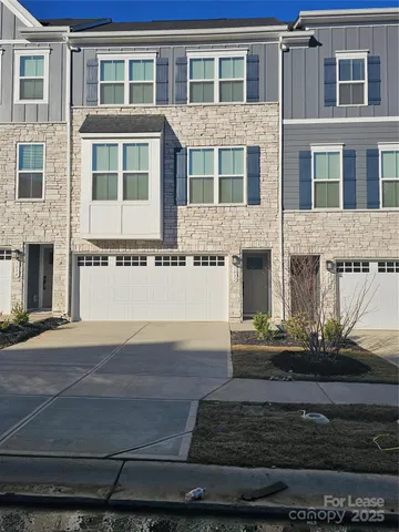 a front view of a house with lots of green space