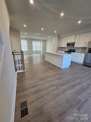 a view of kitchen with cabinets and wooden floor