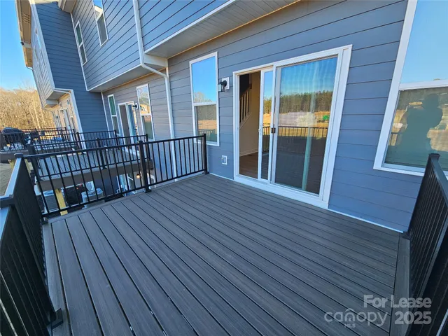 a view of backyard with deck and wooden floor