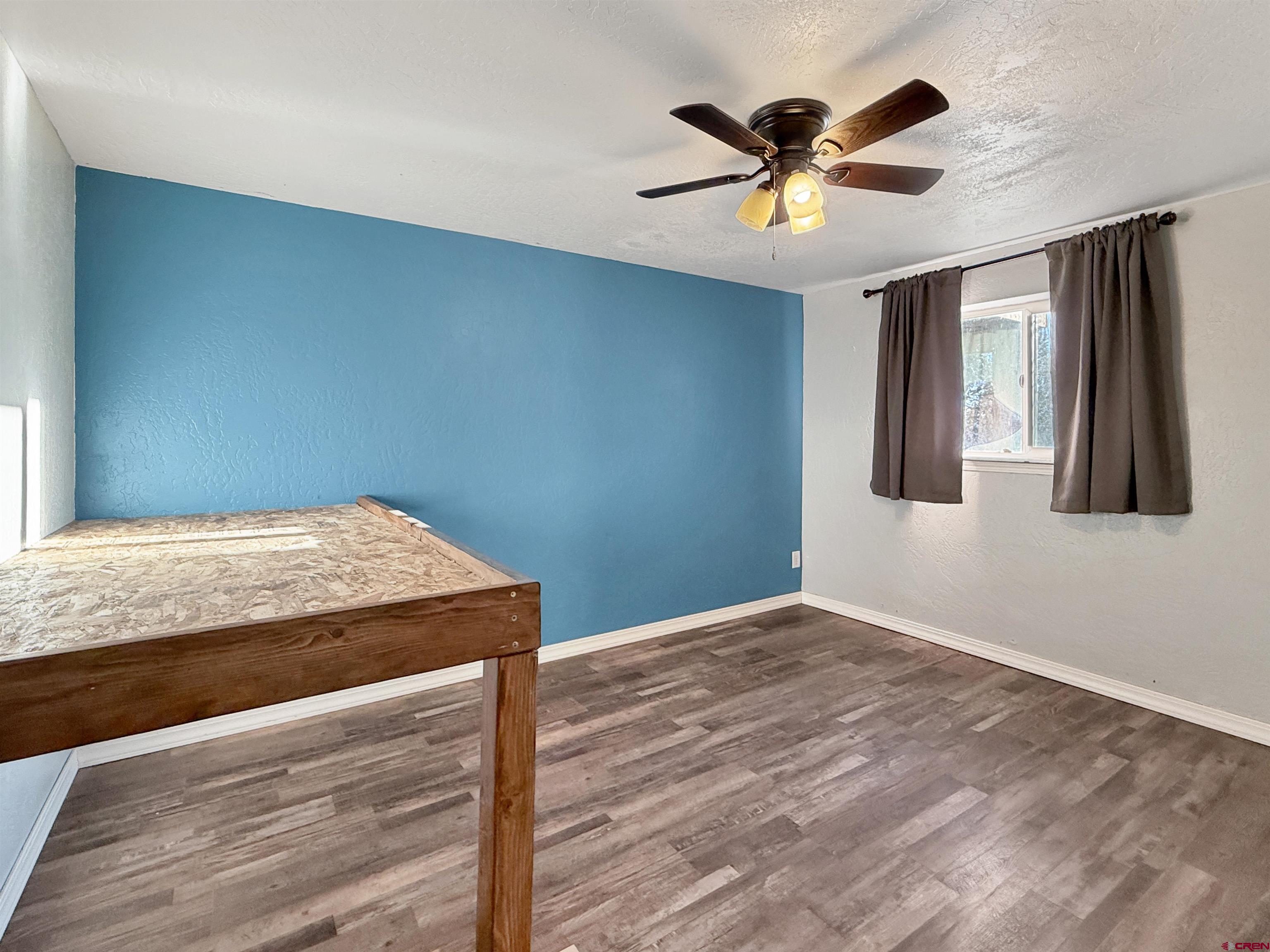 27425 Rd P.7 Dolores, CO 81323 - Photo 35 of 44 a view of a livingroom with a ceiling fan and wooden floor