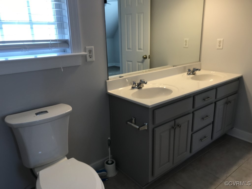 7235 Hopkins Road Richmond, VA 23237 - Photo 14 of 14 a bathroom with a sink vanity mirror and toilet