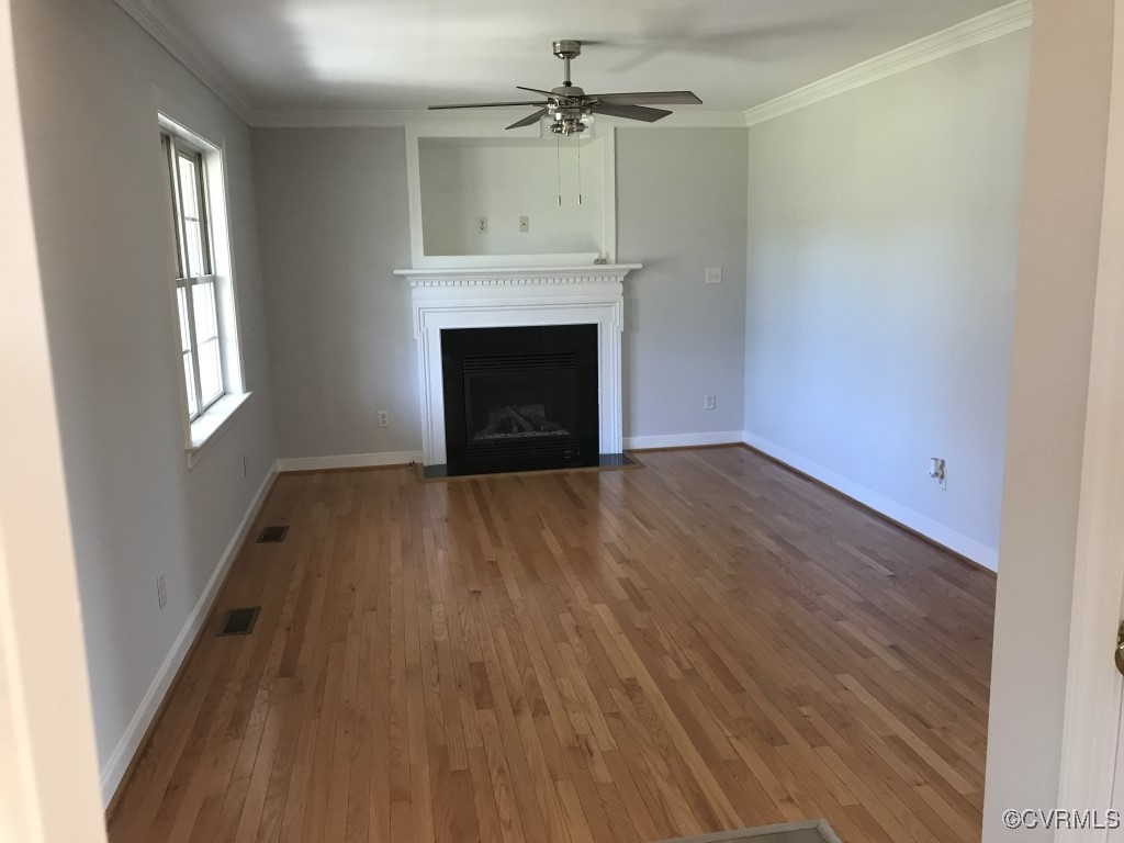 7235 Hopkins Road Richmond, VA 23237 - Photo 3 of 14 wooden floor in an empty room with a fireplace