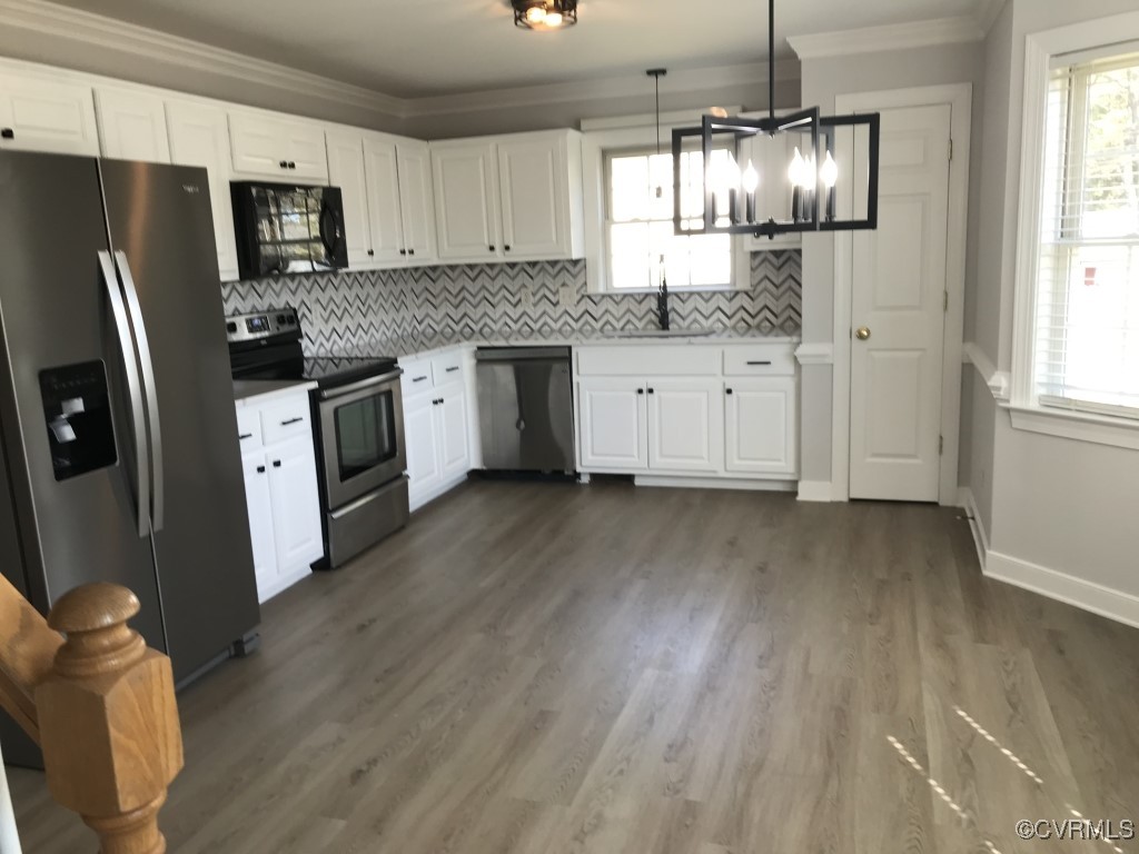 7235 Hopkins Road Richmond, VA 23237 - Photo 5 of 14 a kitchen with granite countertop a refrigerator a sink dishwasher a stove and white cabinets with wooden floor