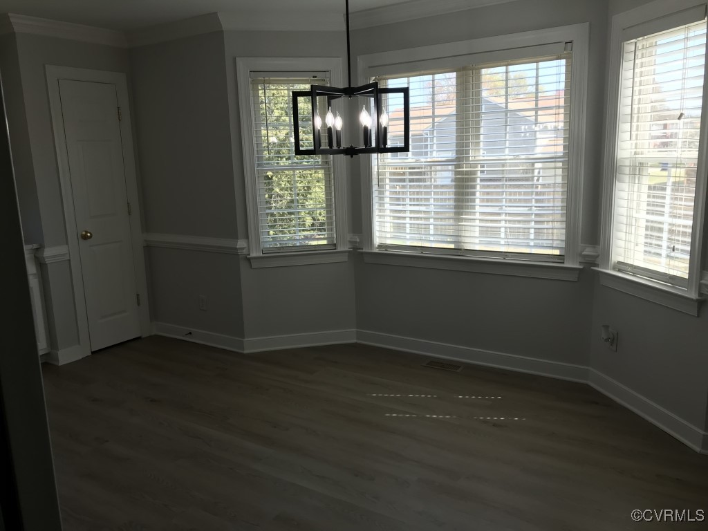 7235 Hopkins Road Richmond, VA 23237 - Photo 6 of 14 an empty room with wooden floor and windows