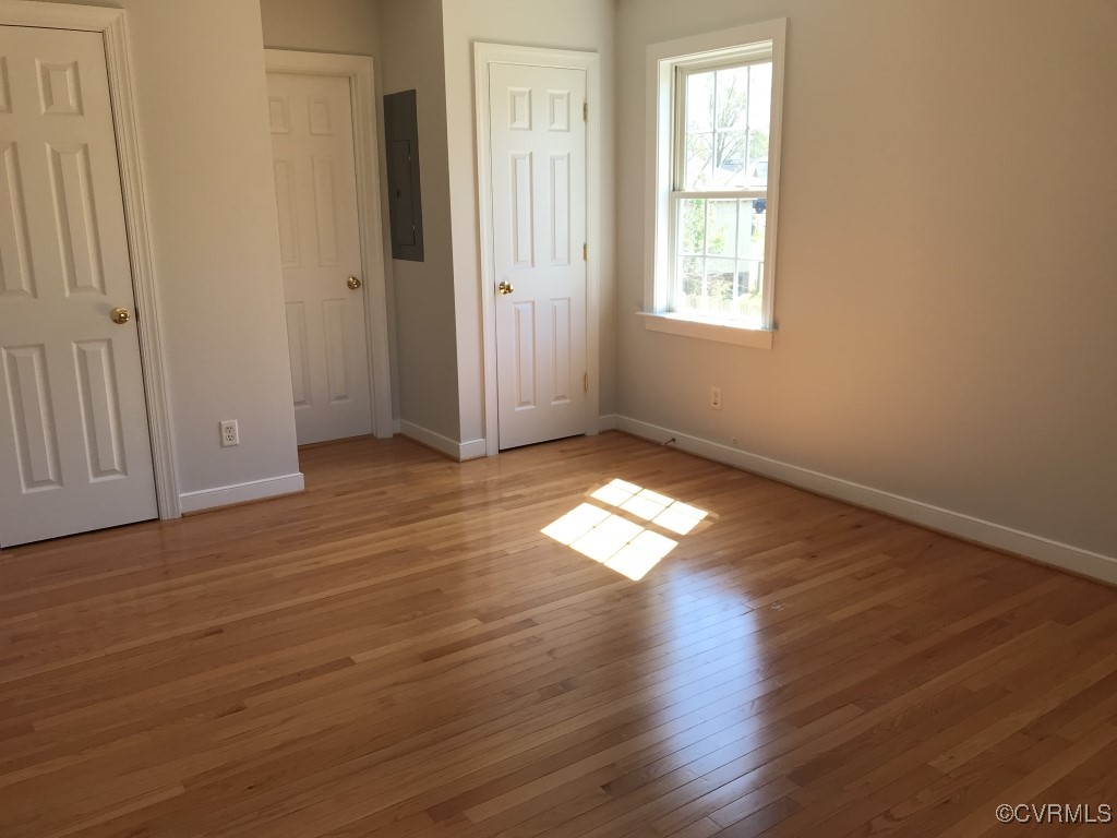 7235 Hopkins Road Richmond, VA 23237 - Photo 7 of 14 an empty room with wooden floor and windows