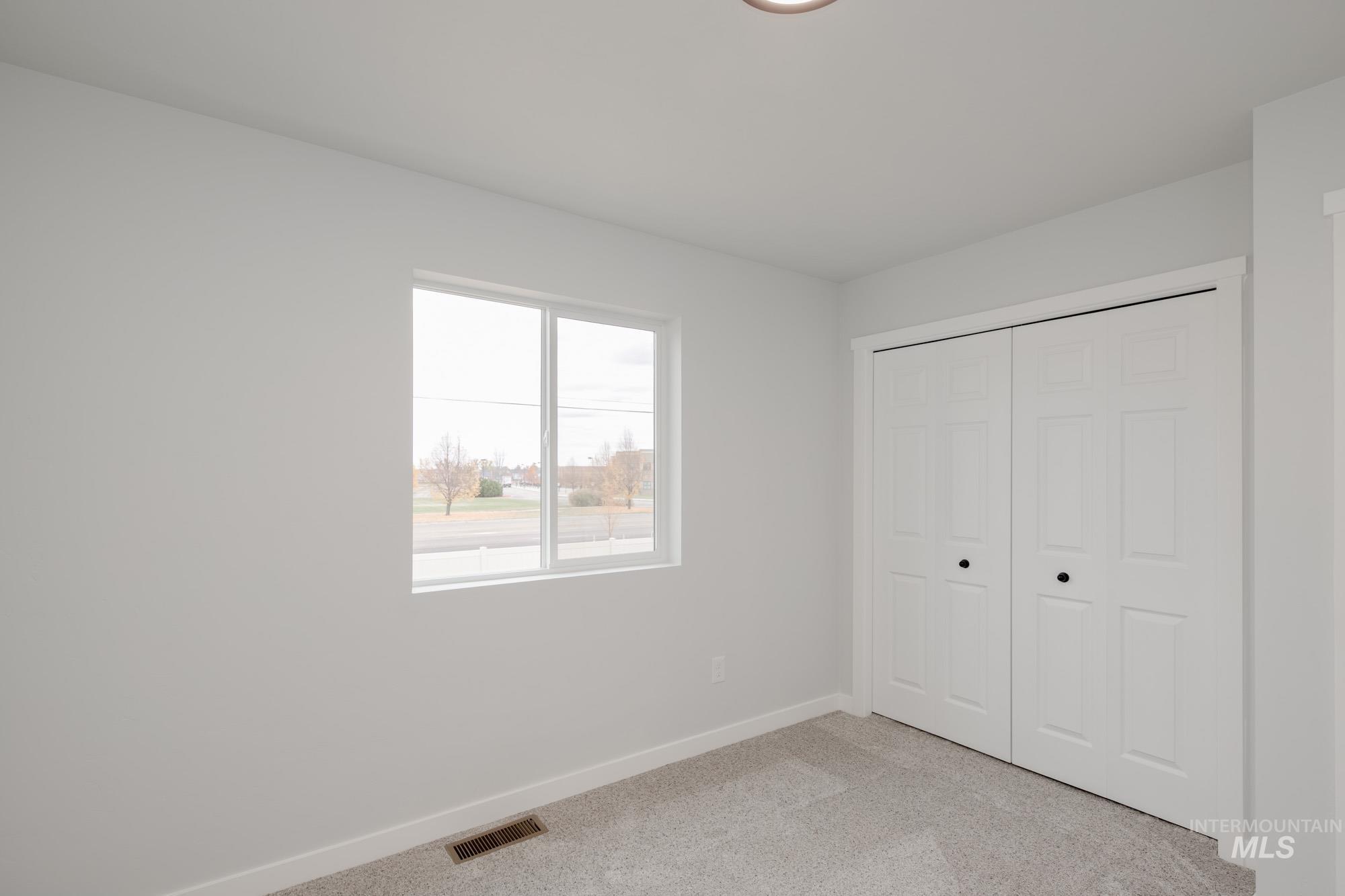 3005 South Maple Rnch Way Nampa, ID 83686 - Photo 21 of 25 Unfurnished bedroom with light carpet and a closet