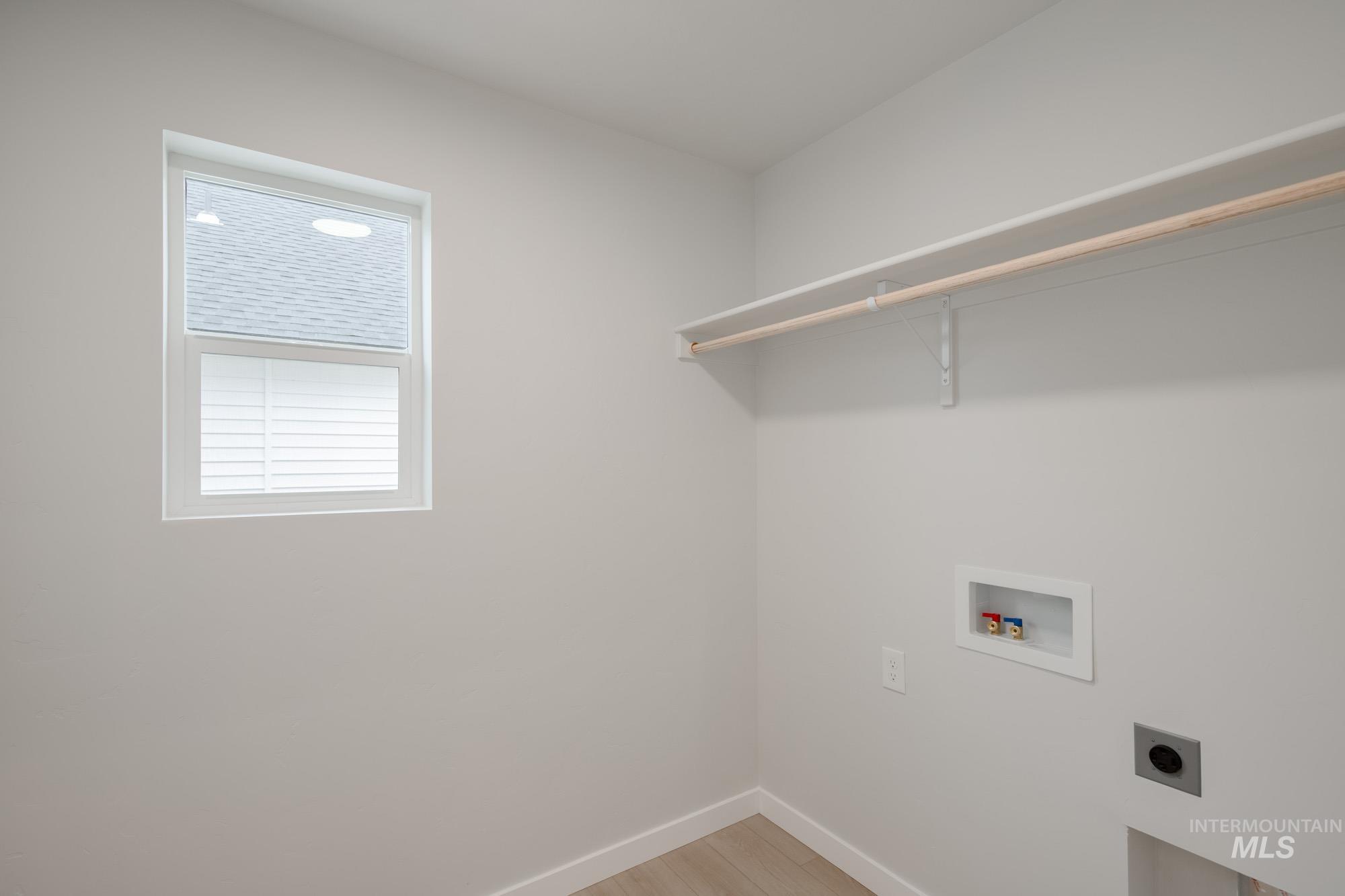 3005 South Maple Rnch Way Nampa, ID 83686 - Photo 24 of 25 Washroom featuring light wood finished floors, hookup for a washing machine, and hookup for an electric dryer