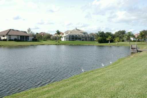 105 Northwest S Shore Road Stuart, FL 34994 - Photo 8 of 8 a view of a lake with houses in the back