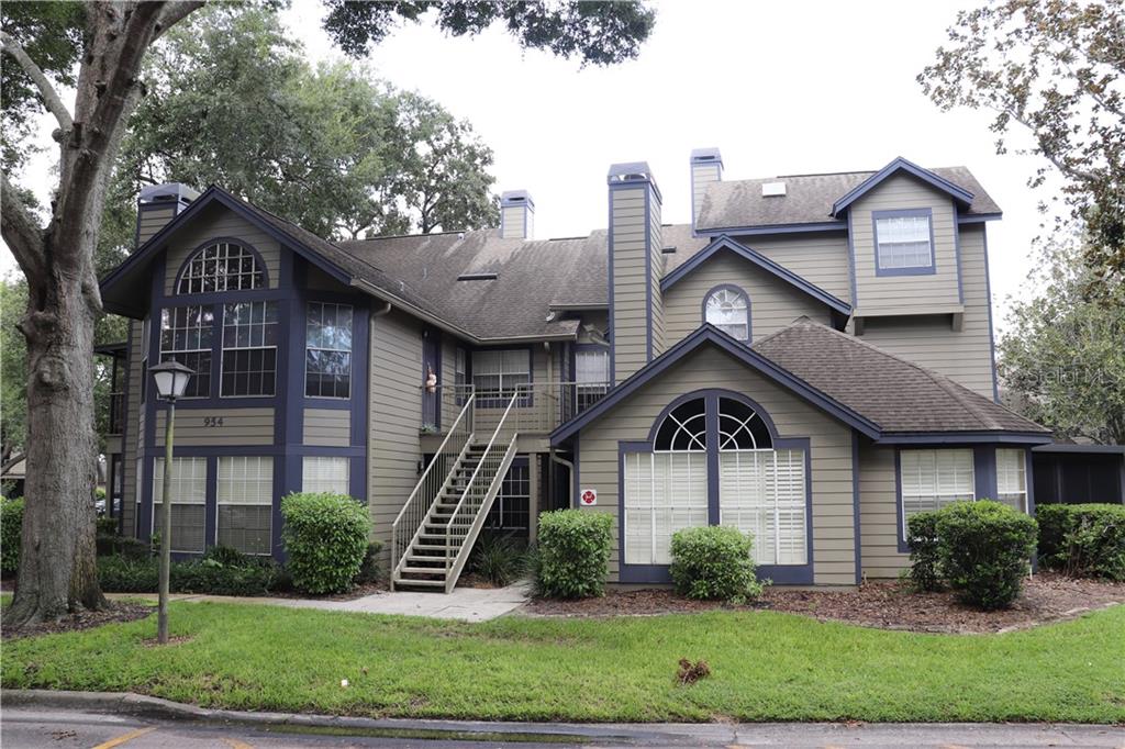 954 Forest Ridge Court, Unit 202 Lake Mary, FL 32746 - Photo 1 of 1 a front view of a house with garden