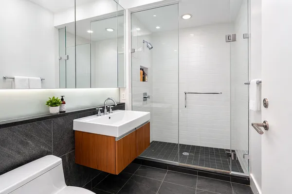 a spacious bedroom with a bed and wooden floor