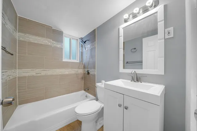 a bathroom with a sink double vanity mirror and toilet