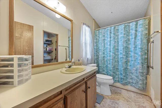a bathroom with a sink mirror and toilet