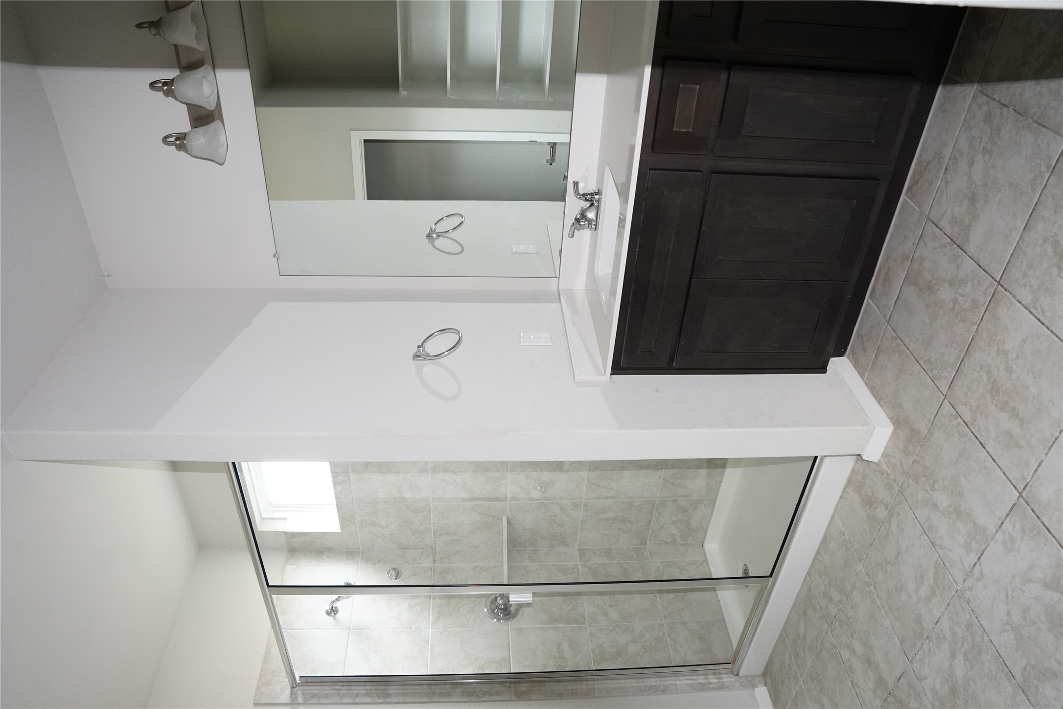 117 Crescent Street Georgetown, TX 78626 - Photo 36 of 38 A well-lit primary bathroom features a spacious glass-enclosed shower alongside a sleek vanity with ample counter space.
