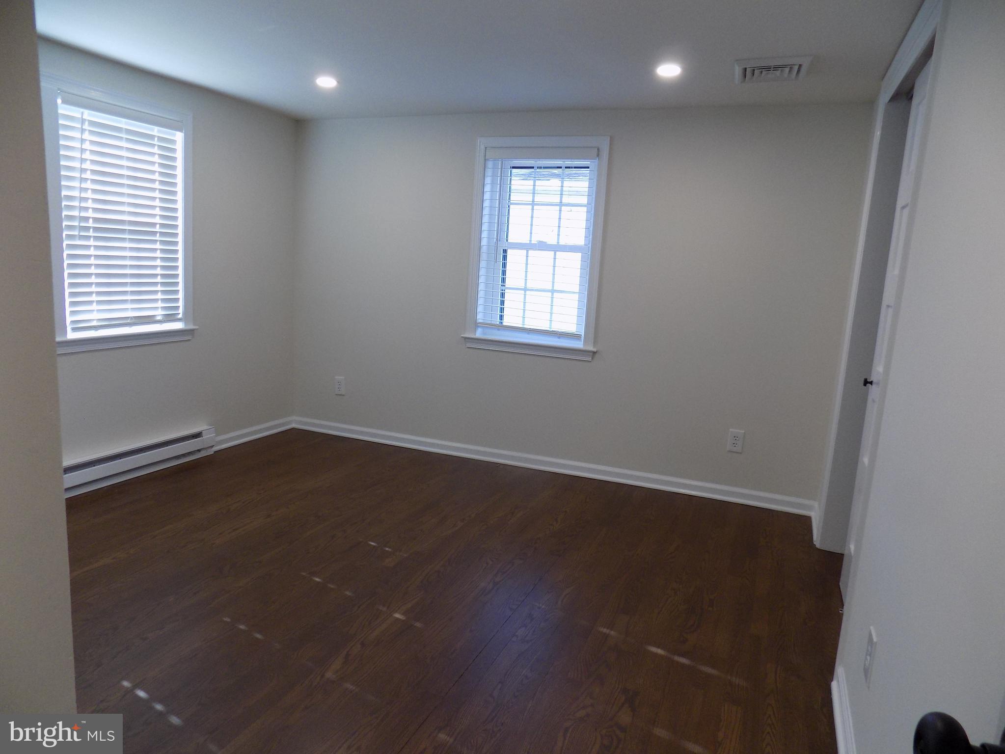 114 North Penrose Street Quakertown, PA 18951 - Photo 17 of 25 an empty room with wooden floor and windows