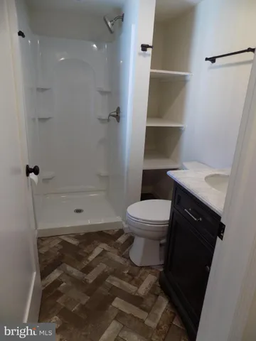 a bathroom with a toilet and a shower
