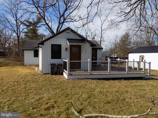a view of a house with wooden fence