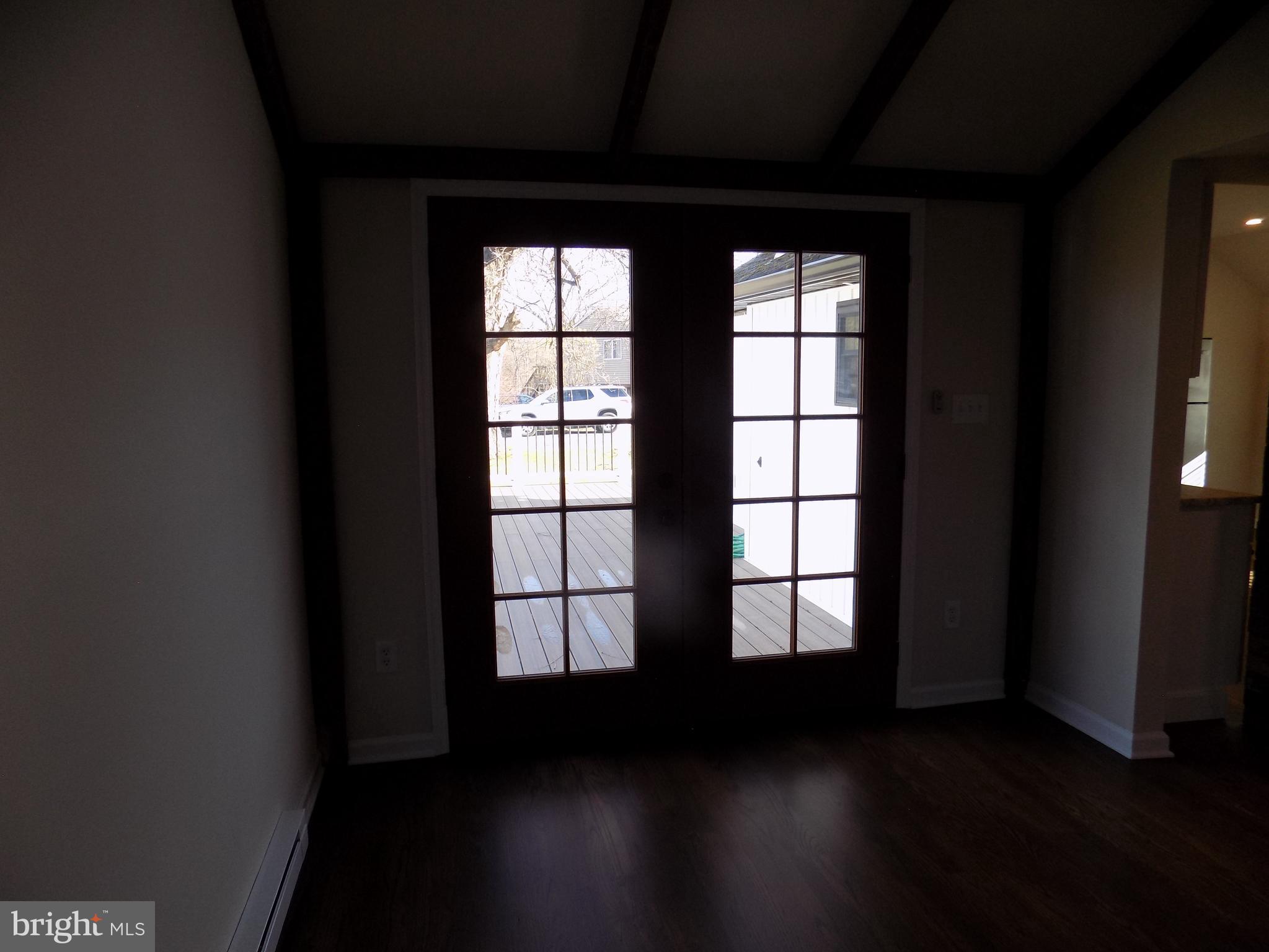 114 North Penrose Street Quakertown, PA 18951 - Photo 22 of 25 a view of an empty room with wooden floor and a window