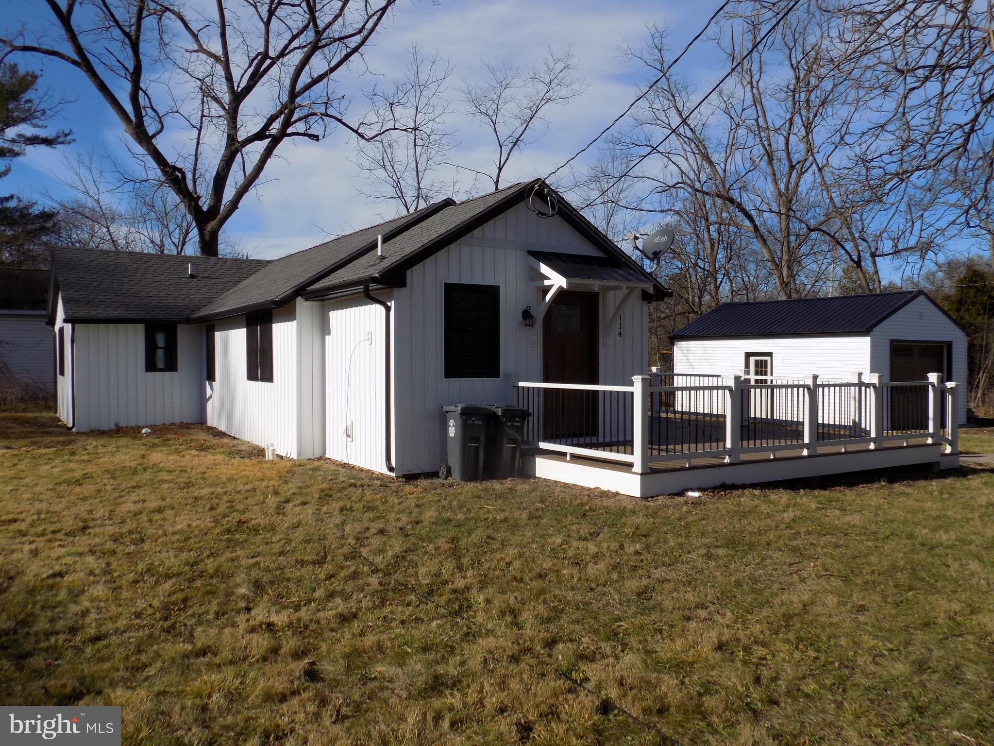 114 North Penrose Street Quakertown, PA 18951 - Photo 3 of 25 a view of a house with wooden walls and a large tree