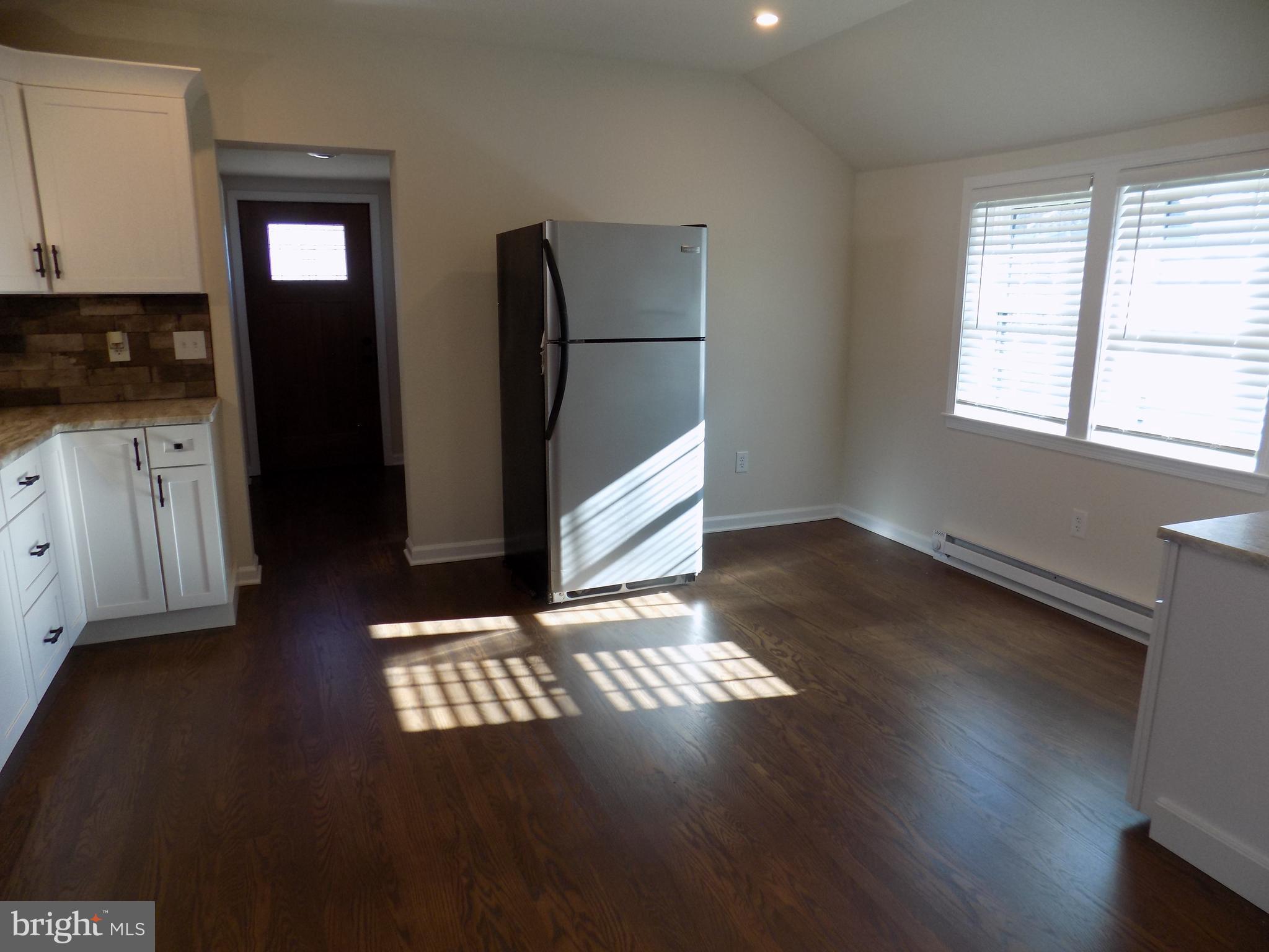 114 North Penrose Street Quakertown, PA 18951 - Photo 6 of 25 a view of an empty room with window and wooden floor