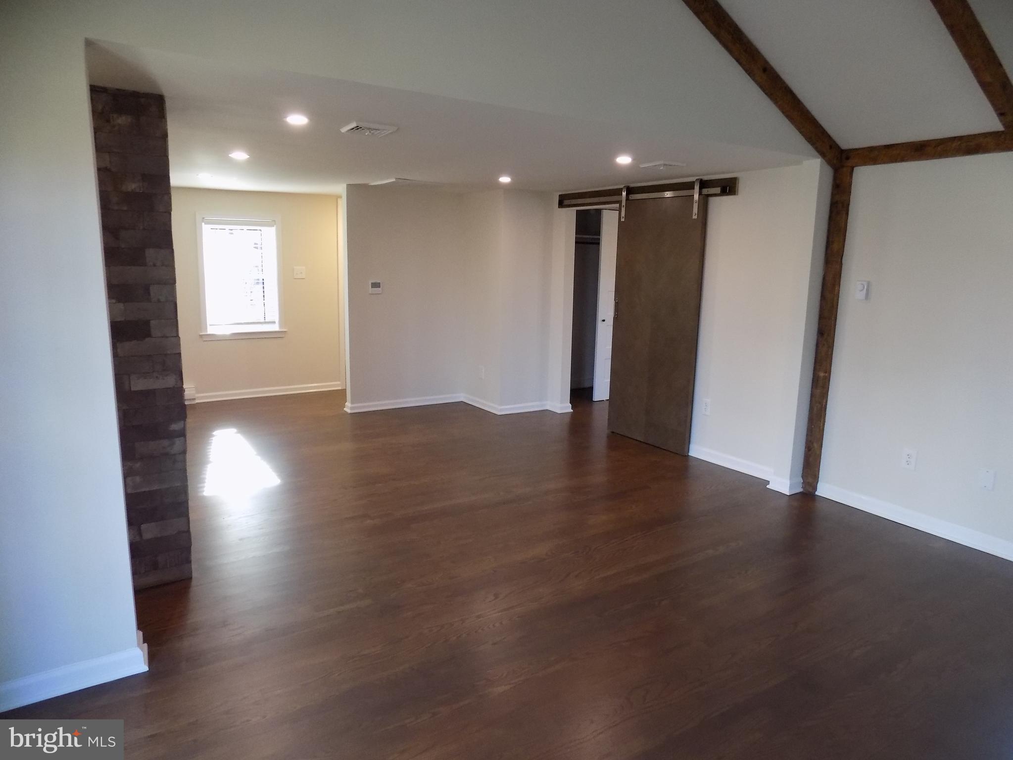 114 North Penrose Street Quakertown, PA 18951 - Photo 10 of 25 a view of an empty room with wooden floor and a window