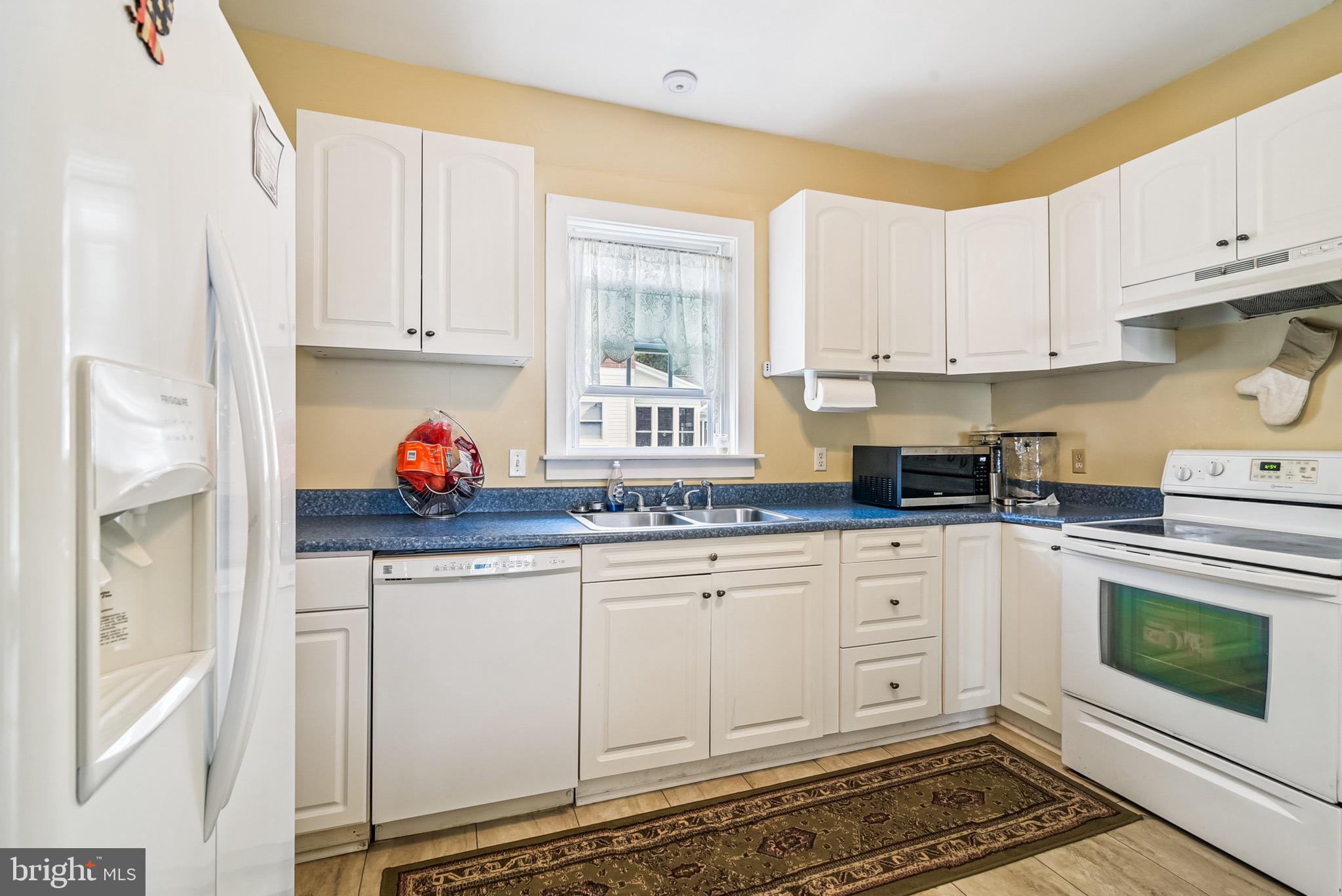 16 Columbia Avenue Crisfield, MD 21817 - Photo 17 of 36 a kitchen with stainless steel appliances granite countertop a stove a sink and a white cabinets
