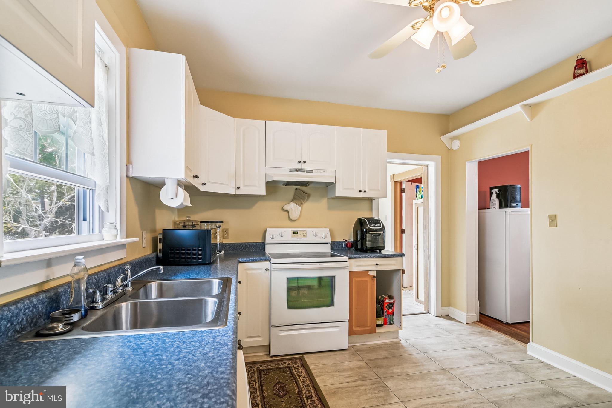 16 Columbia Avenue Crisfield, MD 21817 - Photo 18 of 36 a kitchen with stainless steel appliances granite countertop a stove and a sink