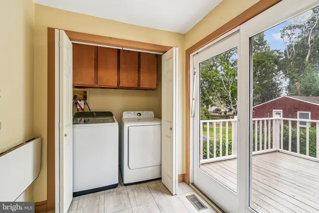 a view of a hallway with washer and dryer