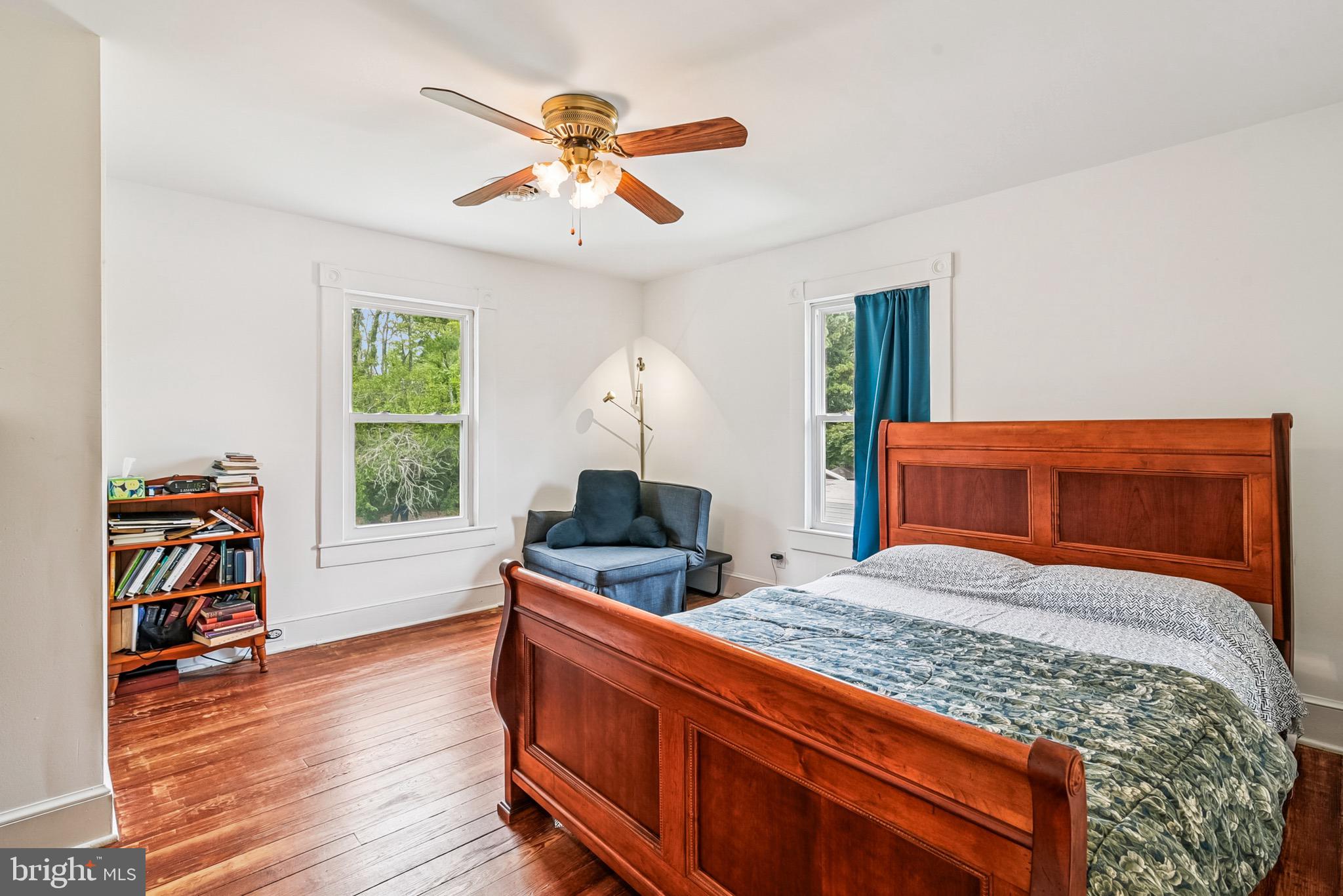 16 Columbia Avenue Crisfield, MD 21817 - Photo 22 of 36 a bedroom with a bed and a chandelier