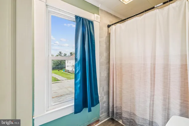 a view of a deck with two chairs and wooden fence