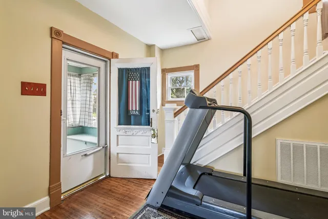a view of an entryway with wooden floor and stairs