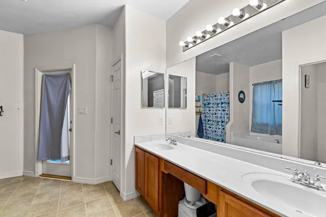 a bathroom with a sink double vanity and a mirror