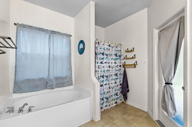 a bathroom with a shower and a sink