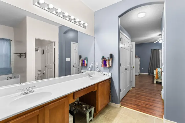 a spacious bathroom with a double vanity sink and a mirror
