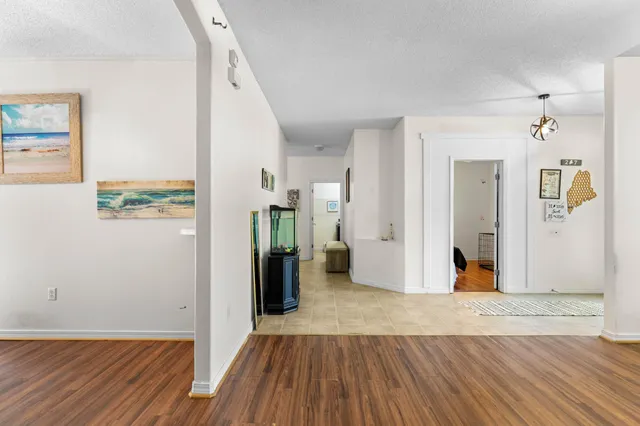 a view of a hallway view with wooden floor and dining room view