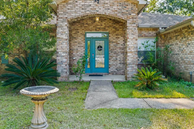 a front view of a house with garden