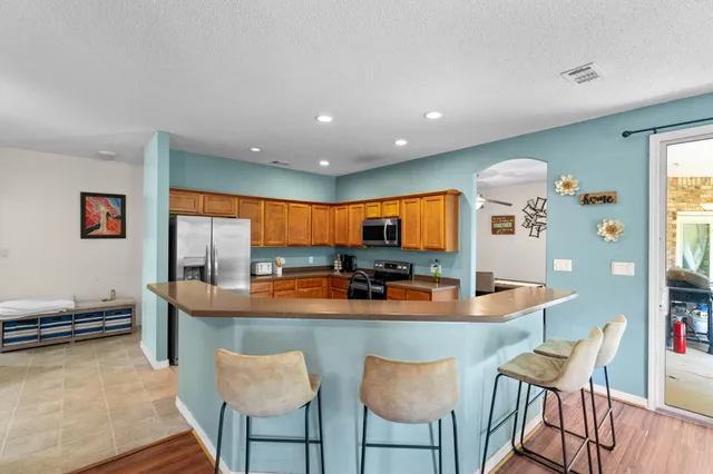 a view of a dining room with furniture a chandelier and wooden floor