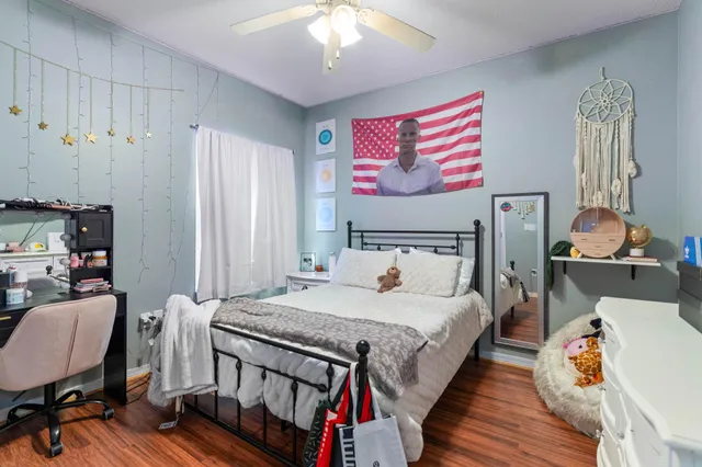 a bedroom with a bed and wooden floor