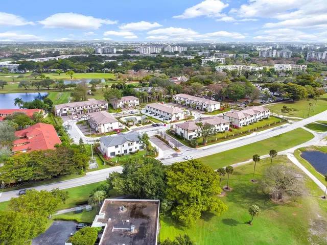 an aerial view of residential houses with outdoor space and river