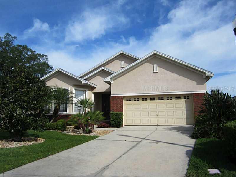 6821 Eagle Ridge Loop Lakeland, FL 33813 - Photo 1 of 1 a front view of a house with a yard and garage