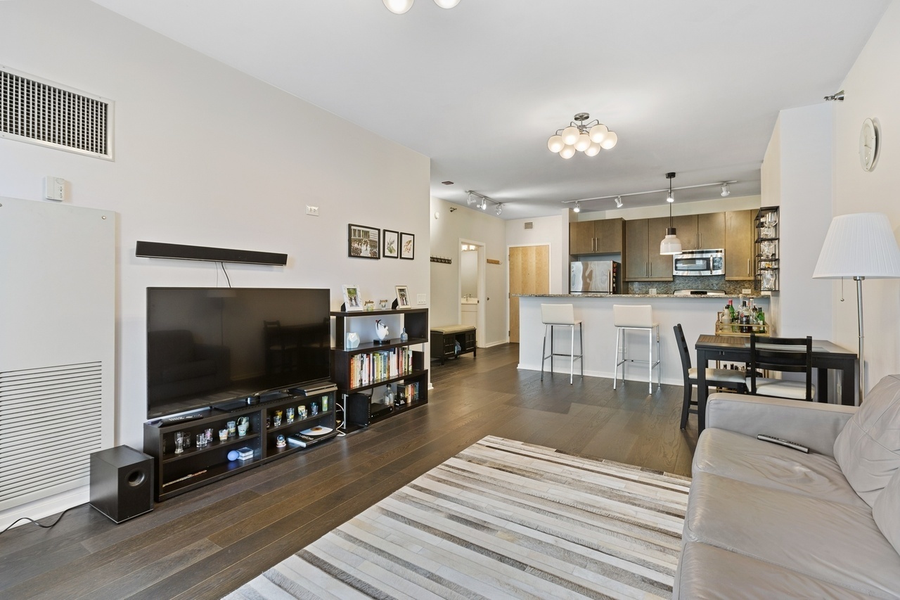 Undisclosed Address Chicago, IL 60607 - Photo 7 of 10 a living room with furniture and a flat screen tv