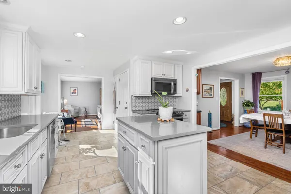a kitchen with sink cabinets and living room