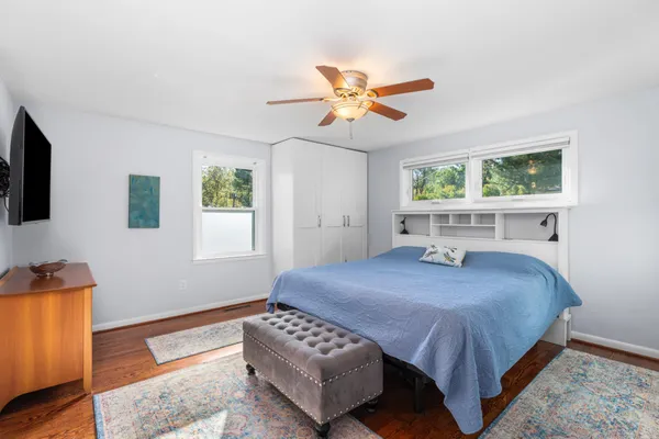 a bedroom with a bed and a chandelier