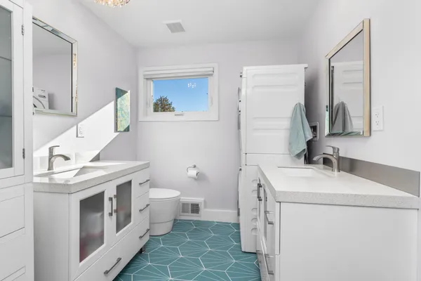 a bathroom with a toilet sink and mirror