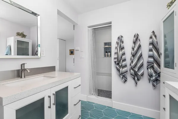 a bathroom with a sink vanity and a mirror