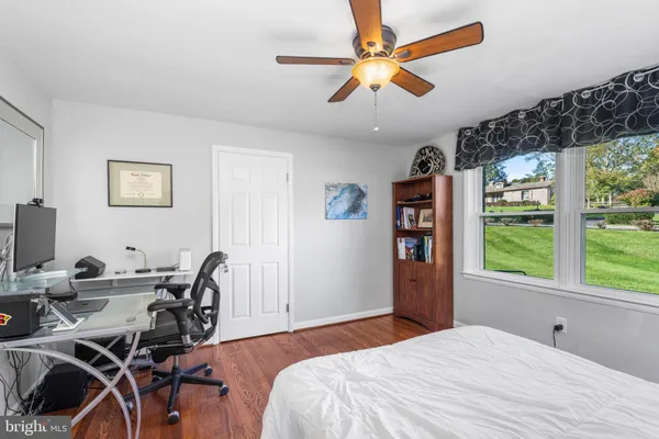 a bedroom with a bed and a large window