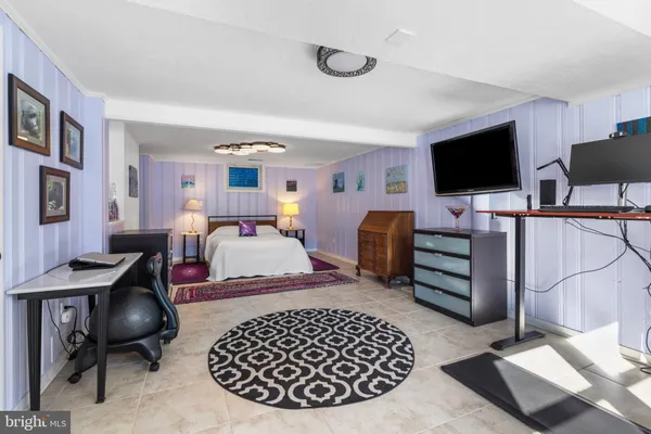 a bedroom with furniture and a flat screen tv